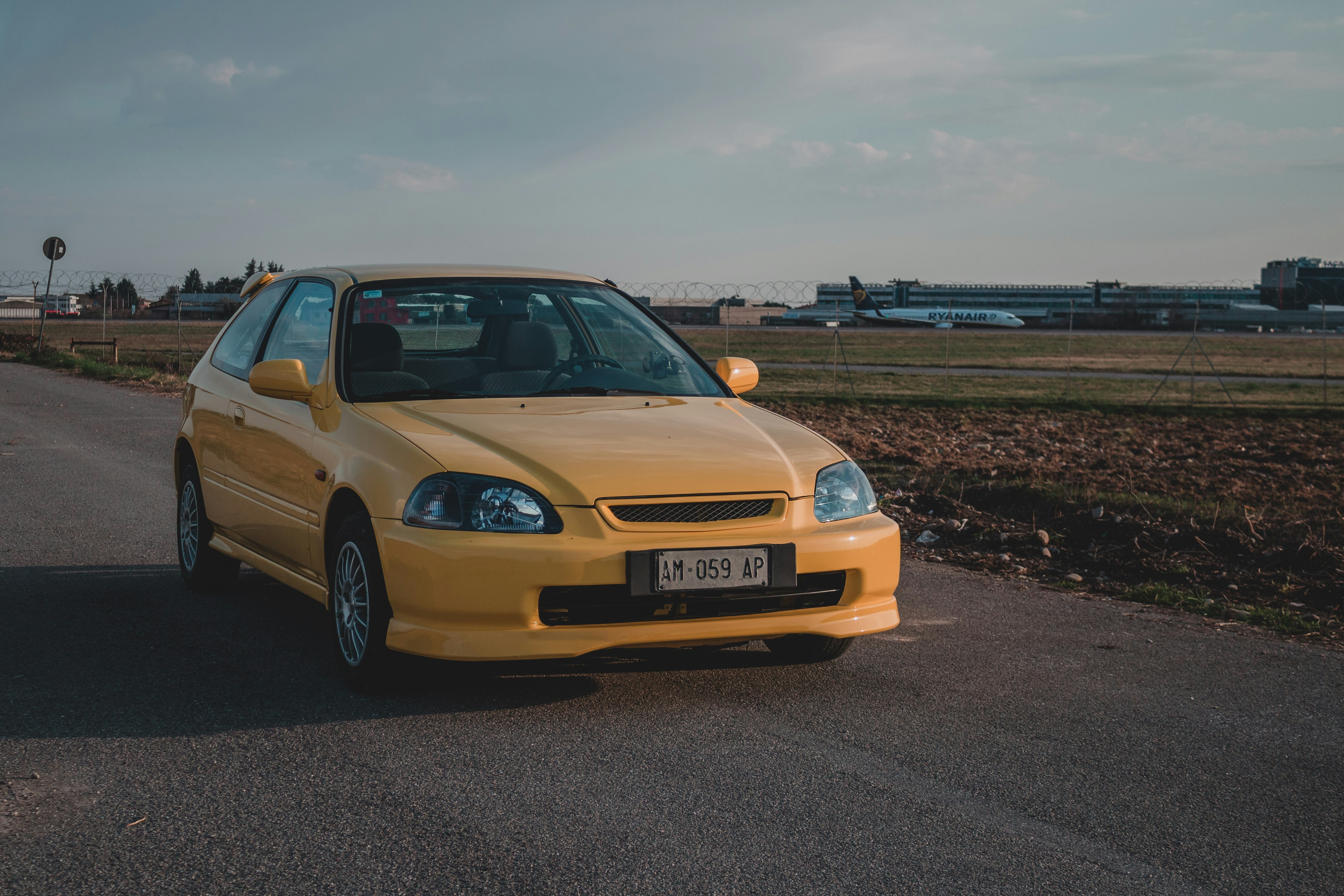 yellow bmw m 3 on road during daytime